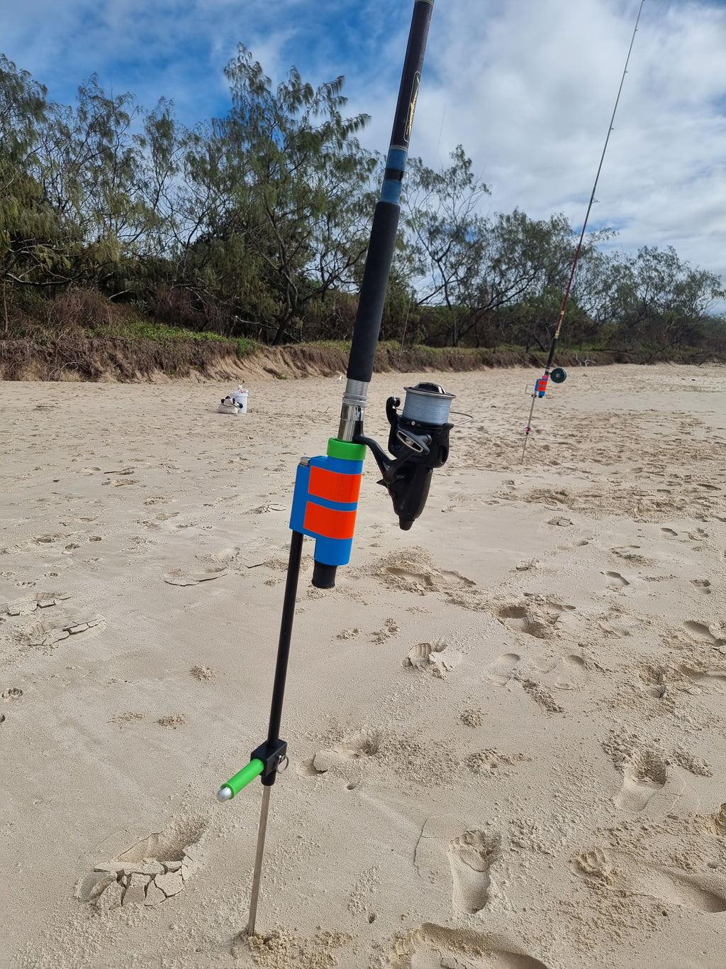 Rod with baitrunner reel in beach fishing rod holder with sand spike