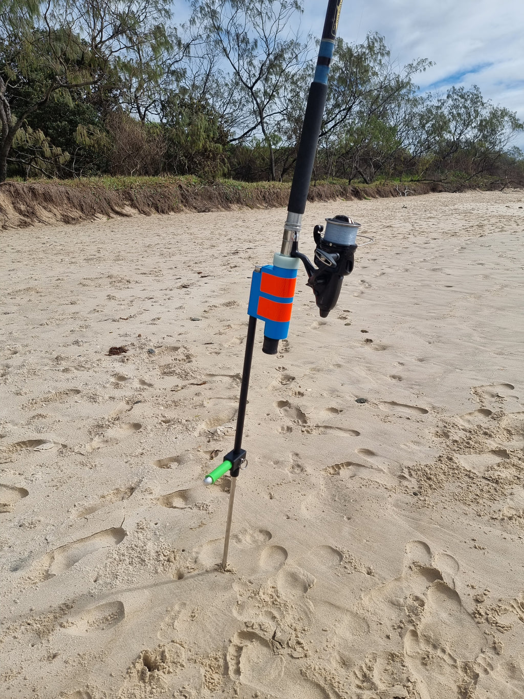 High visibility fishing rod holder on sandy beach