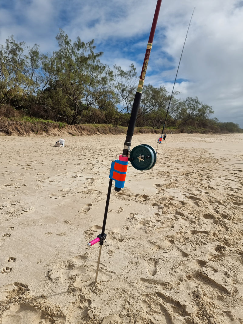 Snyder Glas rod with Avley Reel in Fibreglass and stainless steel fishing rod holder on beach.