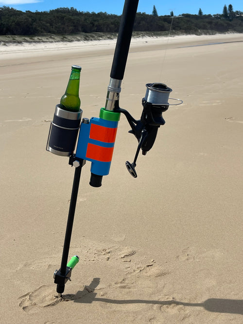 Fishing rod in beach fishing rod holder with beer