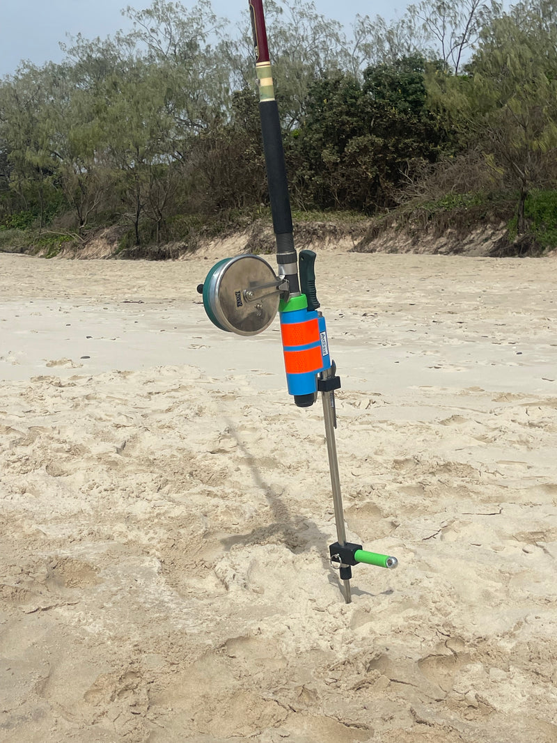 Fishing rod with reel in Aussie Rod Holder on a sandy ground