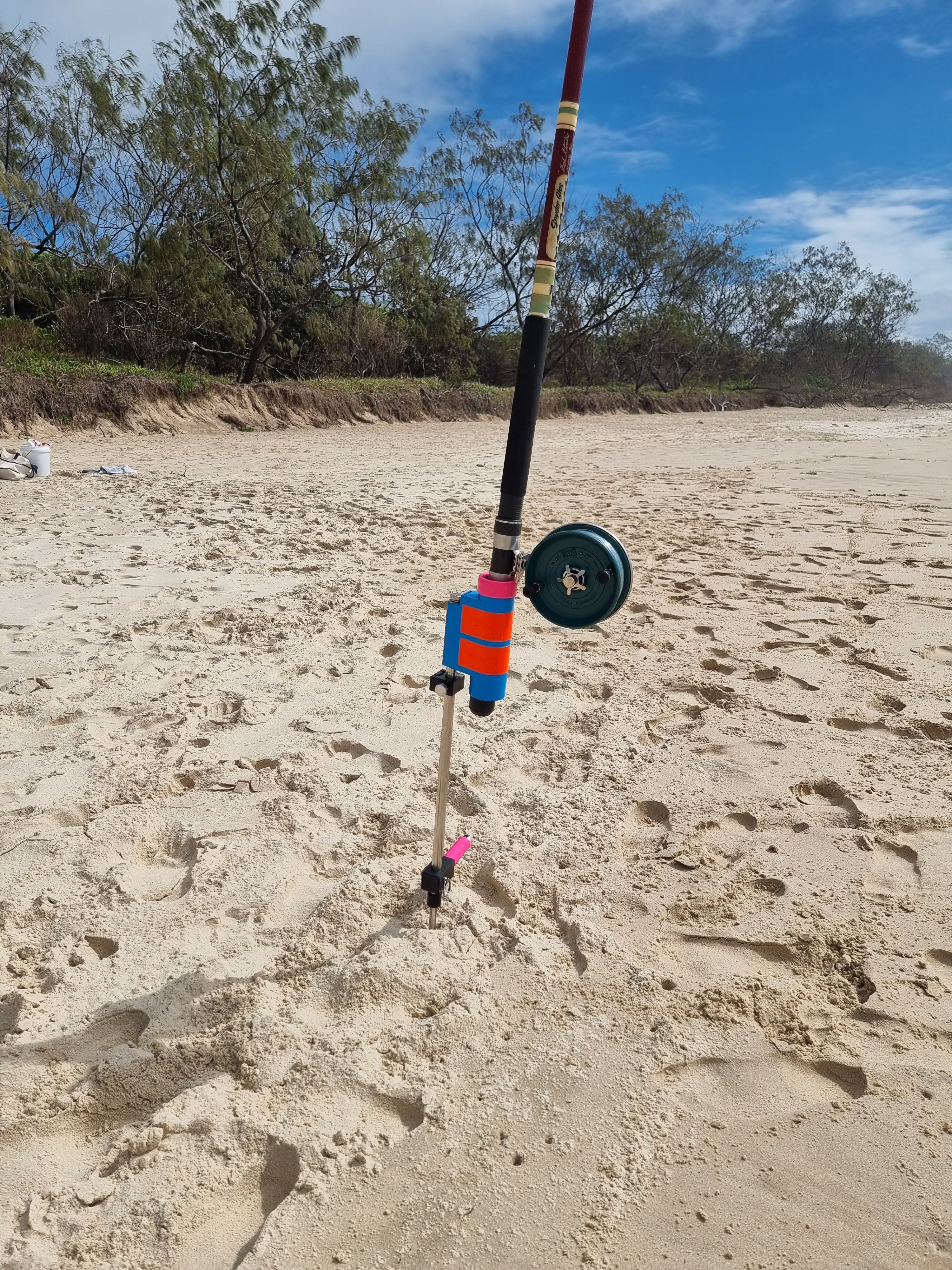 Snyder Glas Rod and Alvey Reel in  fishing rod holder at beach