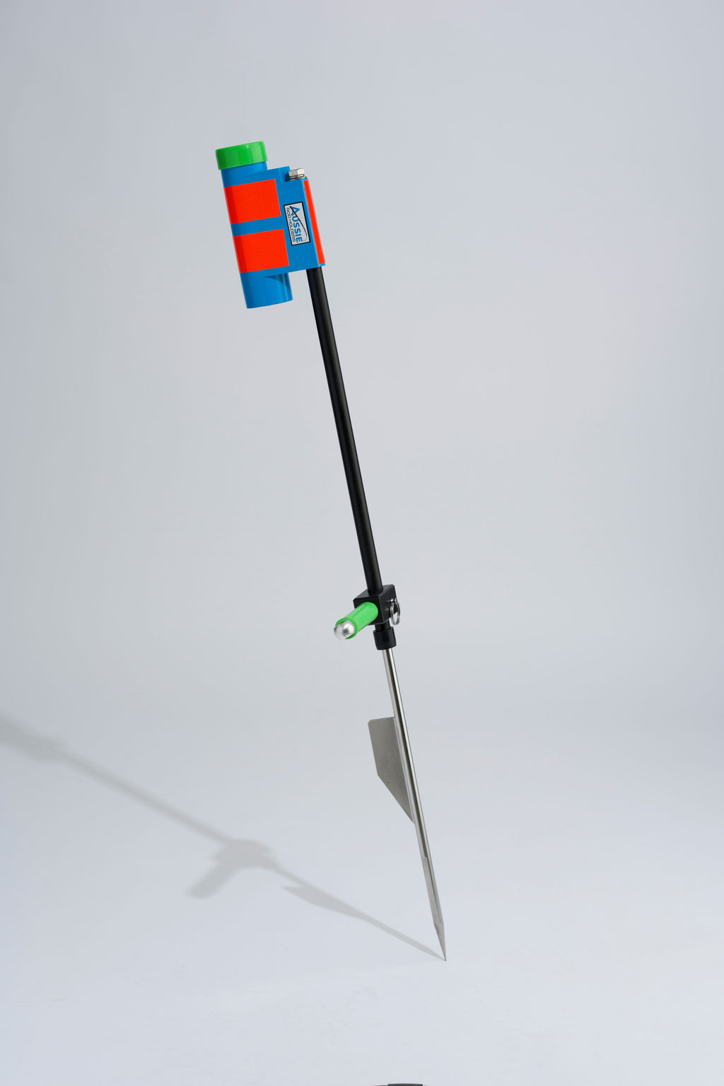 Blue and green fishing rod holder with fibreglass tube, foot peg and stainless steel sand spike on white background